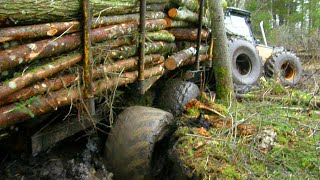 Valtra forestry tractor stuck in mud with big, fully loaded trailer