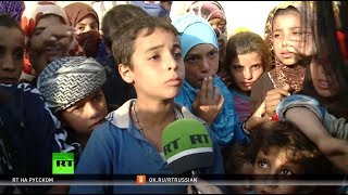 В осаде террористов: жители освобождённого Аль-Маядина рассказали RT о зверствах ИГ