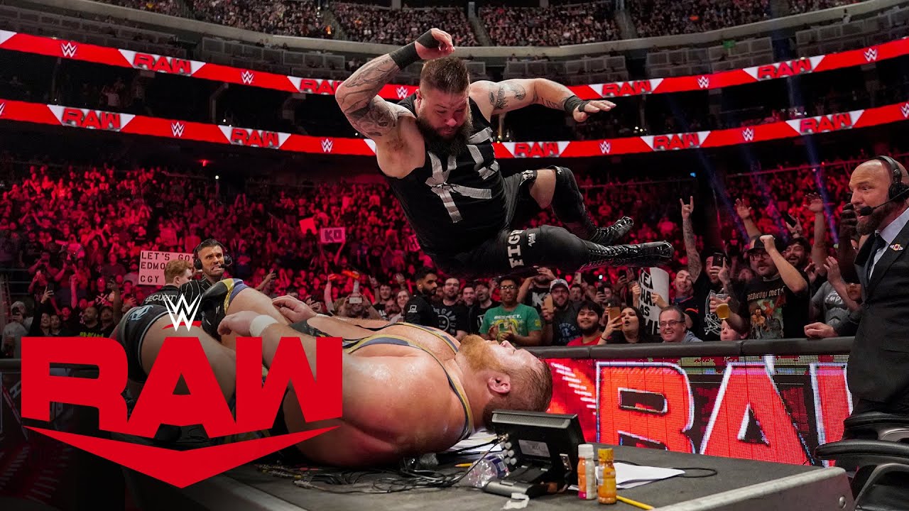 Kevin Owens lays out Otis with an earth-shattering elbow drop onto the announce table.