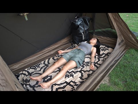 A girl camping alone in a tent that turns into a tarp and a house.