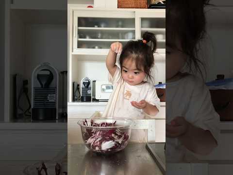 Japanese baby helps mom in the kitchen