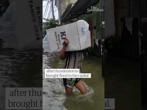 Ballot boxes carried over knee-high floodwater in Jakarta as Indonesia went to the polls