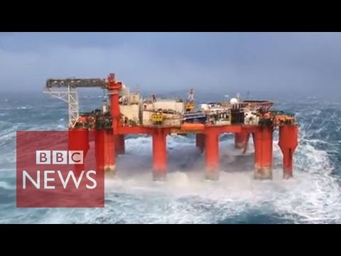 Huge waves crash against swaying North Sea oil rig - UC16niRr50-MSBwiO3YDb3RA