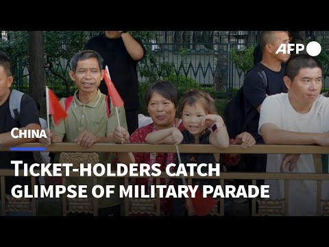 People gather to watch China's massive military parade in Beijing | AFP