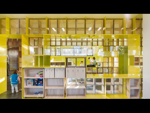 Walls with integrated furniture and yellow nooks encourage play in Madrid school