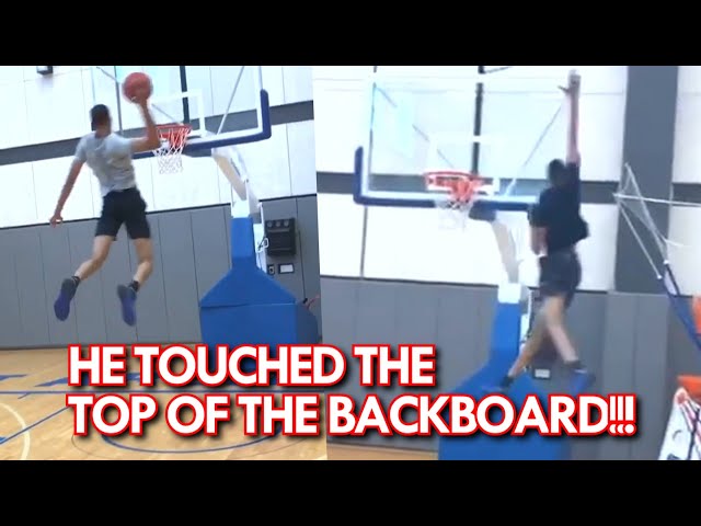 Basketball Player Touches Top Of Backboard