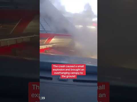 Moment truck crashes into petrol station