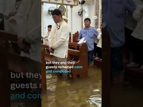 Filipino couple walk down flooded aisle on wedding day  | DW News