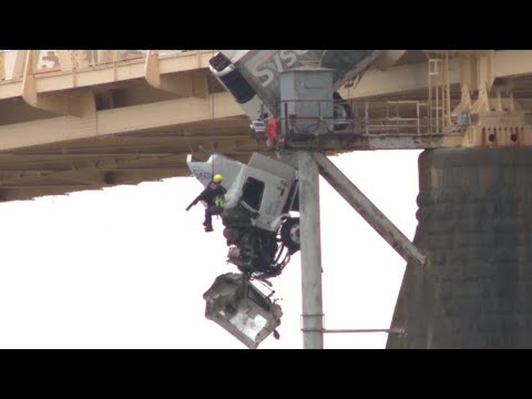 Firefighter abseils to rescue driver of truck hanging off bridge in Kentucky