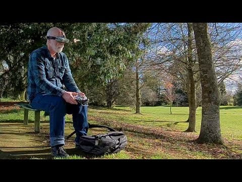 Old man walks, talks and flies a drone in the park - UCQ2sg7vS7JkxKwtZuFZzn-g