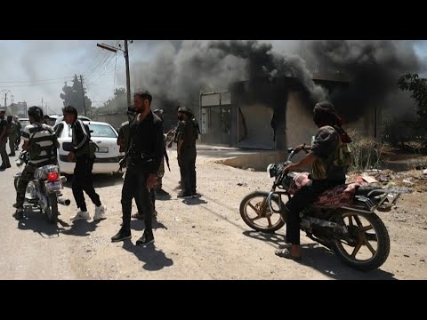 Smoke rises as Syria tribes clash with Druze fighters near Sweida | AFP