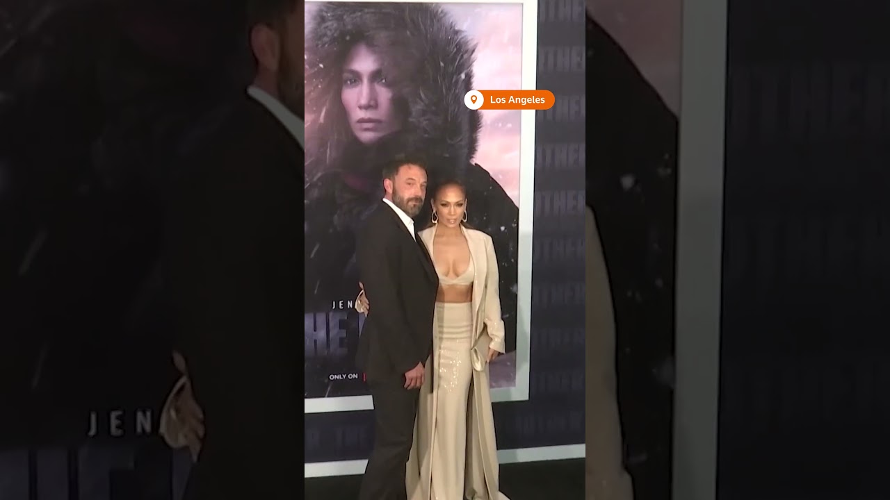 Jennifer Lopez and Ben Affleck share a kiss on the red carpet