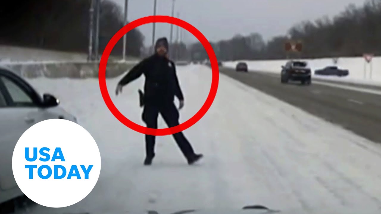 Police officer dodges skidding truck along icy Ohio highway | USA TODAY