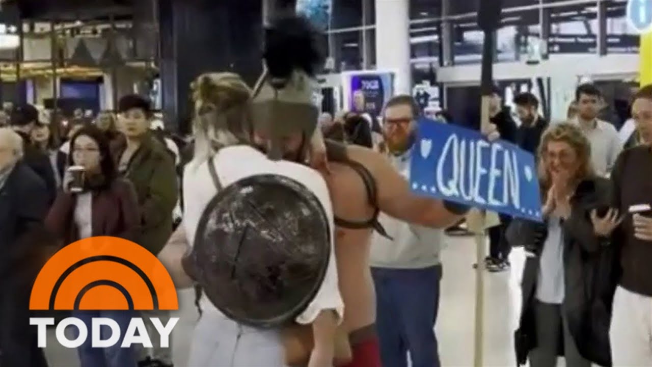 Man dresses as spartan to surprise fiancée at airport