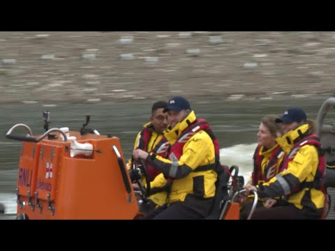 Prince William drives a lifeboat down the Thames | AFP