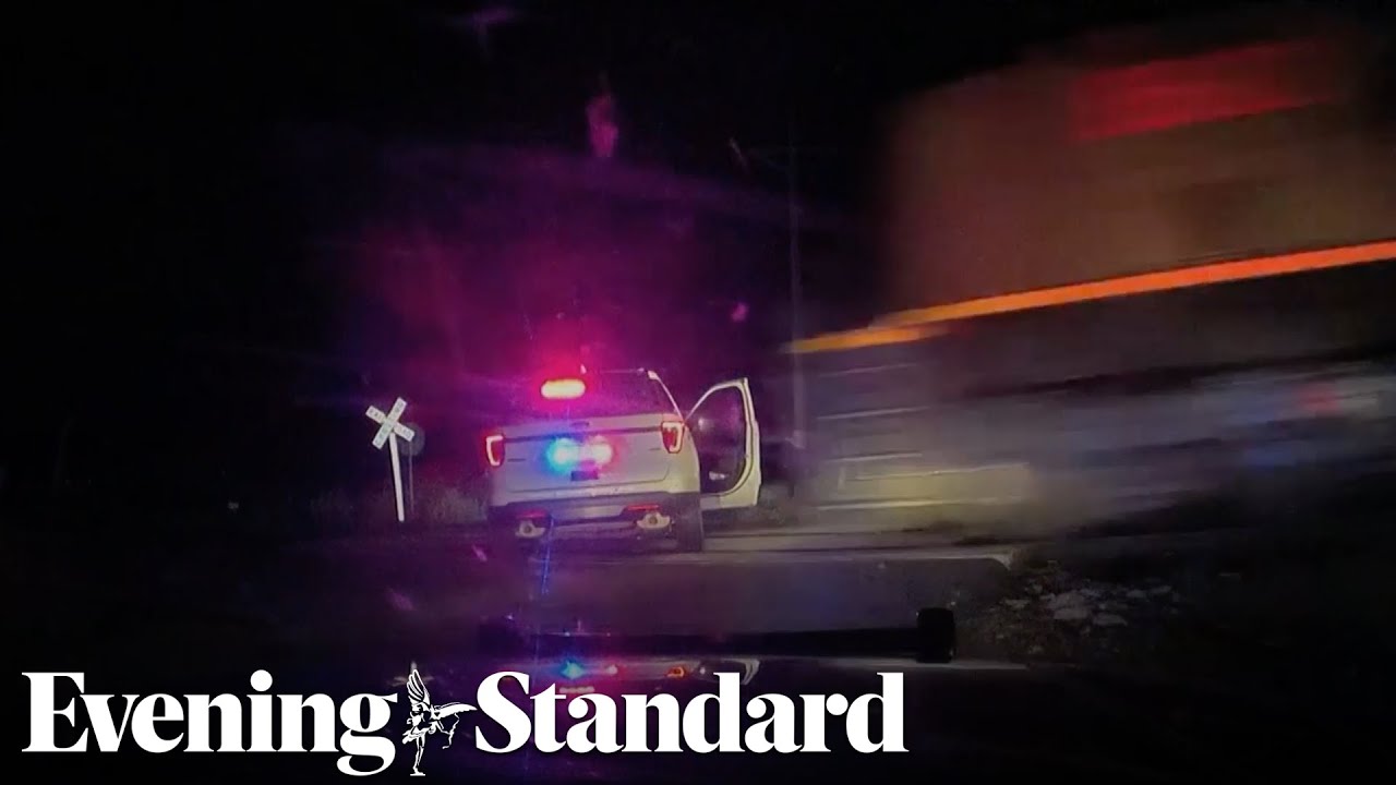 Shocking moment train hits US police car with woman handcuffed inside