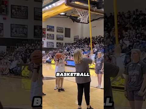 A blind girl takes her first basketball shot