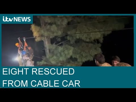 Pakistan: All eight people rescued from cable car stuck 900ft in the air | ITV News