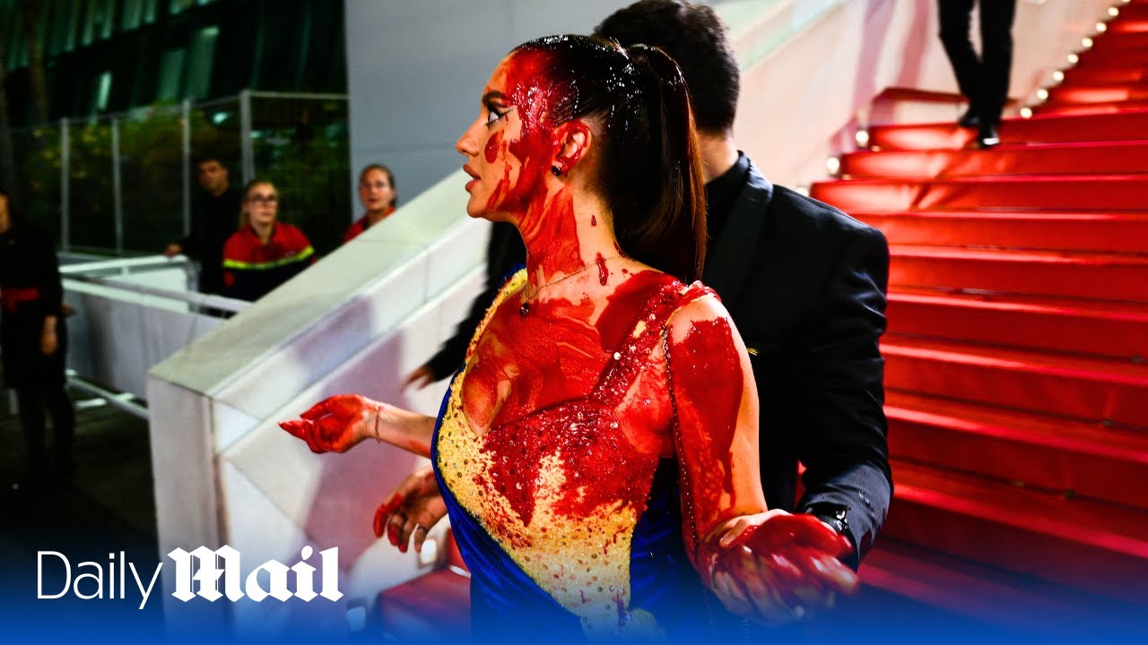 Protester covers herself in fake blood on Cannes Film Festival red carpet