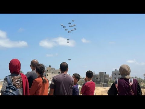 Palestinians watch as aircraft drops aid over central Gaza | AFP