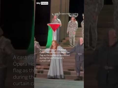 Performer holds Palestinian flag on stage at Royal Opera House