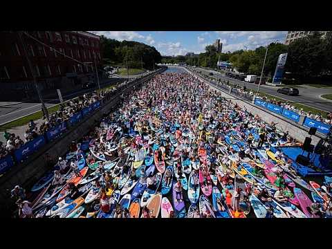 Costumed paddleboarders float down Moscow river in carnival