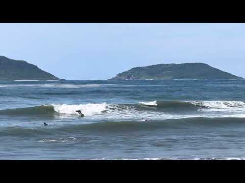 Surfers at Playa Norte, near the Monumento al Oescador, Mazatlán, Mexico