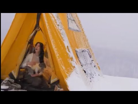 Camping alone in the mountains on a snowy day