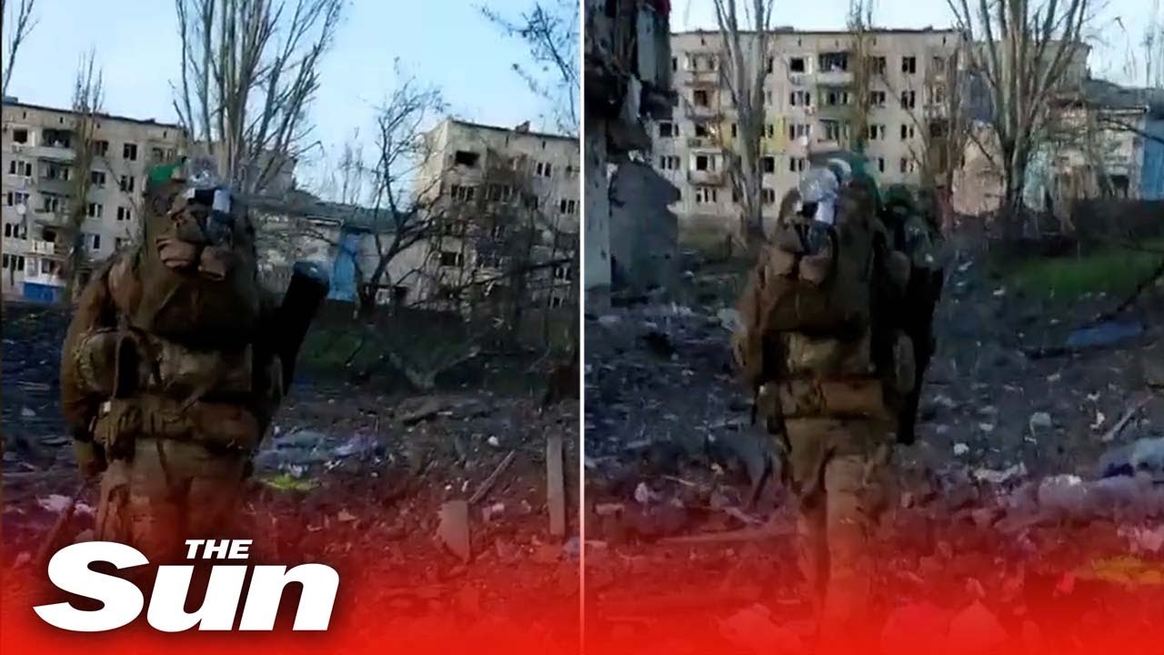 Ukraine SSO soldiers march to combat mission through destroyed city