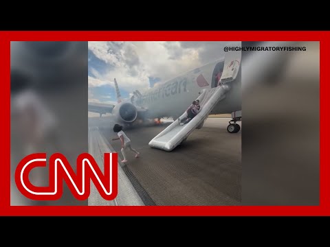 Passengers evacuate plane after landing gear incident sparks fire