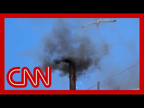 Black smoke rises from the Sistine Chapel after cardinals fail to agree on a new pope