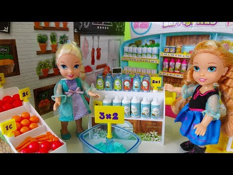 Elsa and Anna toddlers go shopping at the supermarket and buy toys - UCB5mq0ucfGe9dNCIC0s41QQ