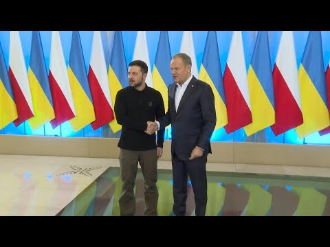 Polish PM Tusk shakes hands with Ukrainian President Zelensky in Warsaw | AFP