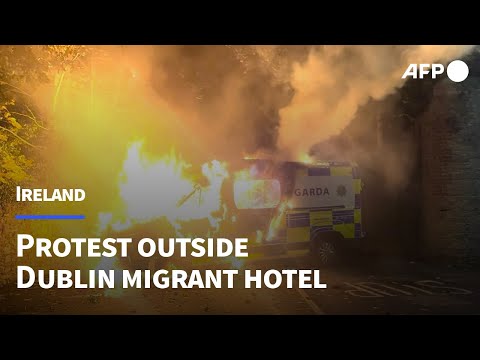 Irish protesters torch police van outside Dublin migrant hotel | AFP