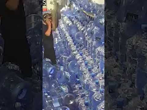 Workers Foolishly Bring Down a Towering Wall of Water Bottles #shorts