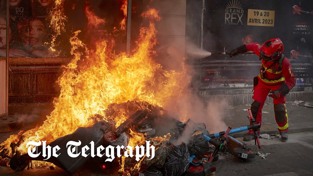Protesters throw e-scooters onto burning piles of rubbish in Paris