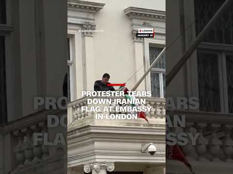 Protester tears down Iranian flag at embassy in London