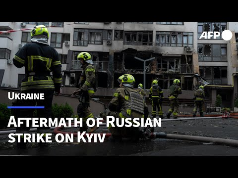 Firefighters clear rubble after overnight Russian strike on Kyiv | AFP