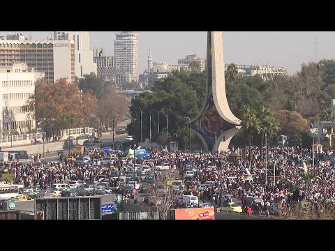 People celebrating in Syrian capital's Umayyad Square a week after Assad was ousted | AFP