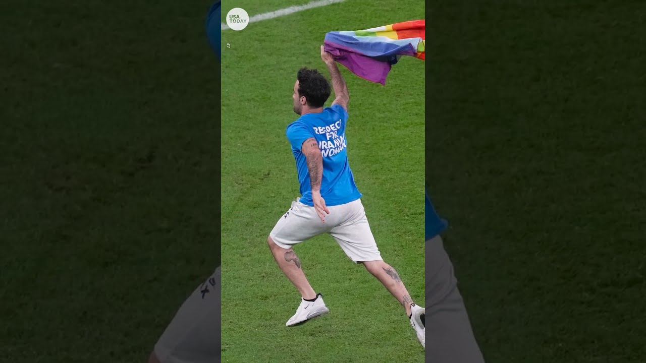 Protester carrying rainbow flag runs onto field at World Cup | USA TODAY #Shorts