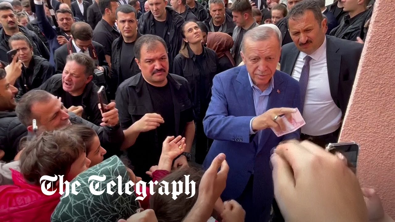 President Erdogan seen handing money to voters at polling station | Turkey election
